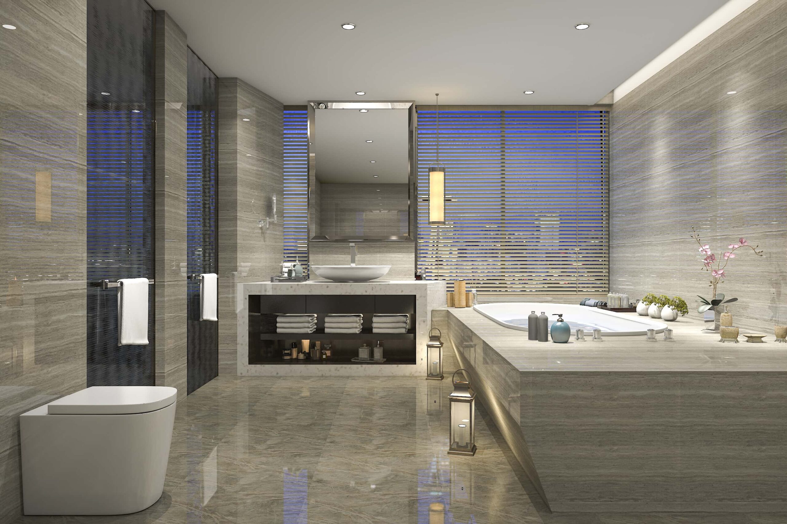 Luxurious modern bathroom with marble surfaces, a freestanding tub, sink, large mirror, and decorative elements like lanterns and plants, overlooking a window with blinds.